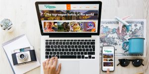 Vegan travel planning on a laptop and phone showing Vegans, Baby travel guides