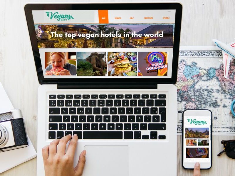 Vegan travel planning on a laptop and phone showing Vegans, Baby travel guides