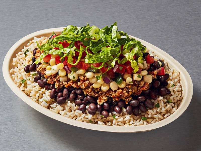 Chipotle vegan bowl with black beans, fajita vegetables, lettuce, and guacamole