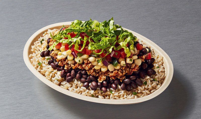 Chipotle vegan bowl with black beans, fajita vegetables, lettuce, and guacamole
