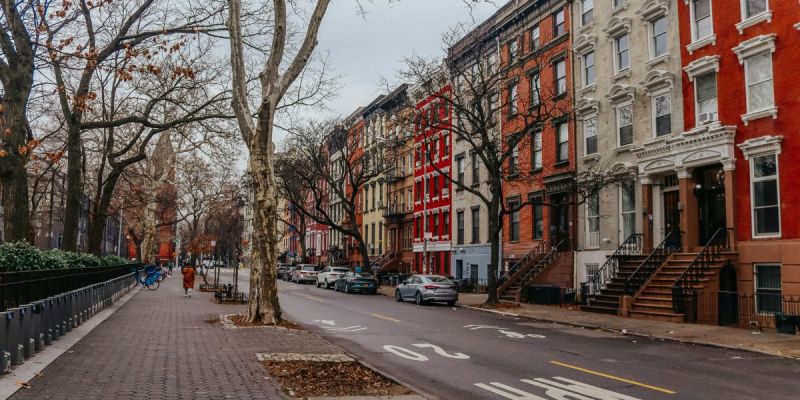 Tree-lined street in the East Village with classic NYC brownstones and quiet neighborhood feel