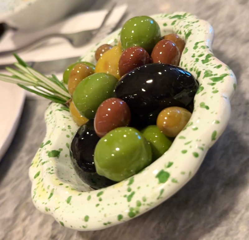 Bowl of marinated olives served at Una Pizza Napoletana in NYC