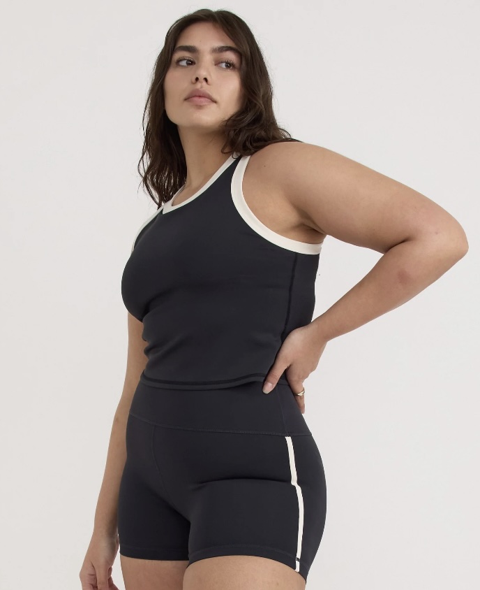 This sleek, minimalist outfit from PANGAIA features a black crewneck sweatshirt made with organic cotton and innovative dye technologies. PANGAIA is a science-led, vegan-friendly brand that blends functionality with sustainability in all its gender-neutral collections.